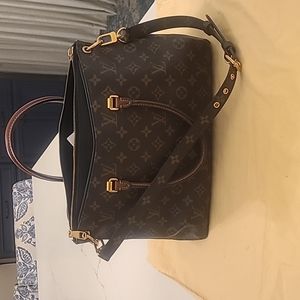 NWOT Louis Vuitton Monogram Pallas, accented with black leather.
